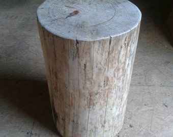 May include: A rustic wooden stool made from a tree trunk, with a natural wood finish and visible grain patterns.
