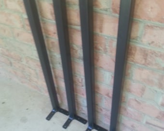 May include: Four black metal table legs with square bases and a flat, angled bracket at the bottom.