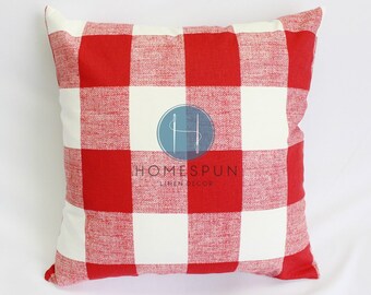 May include: Red and white checkered throw pillow with the text "HOMESPUN LINEN DECOR" in the center.