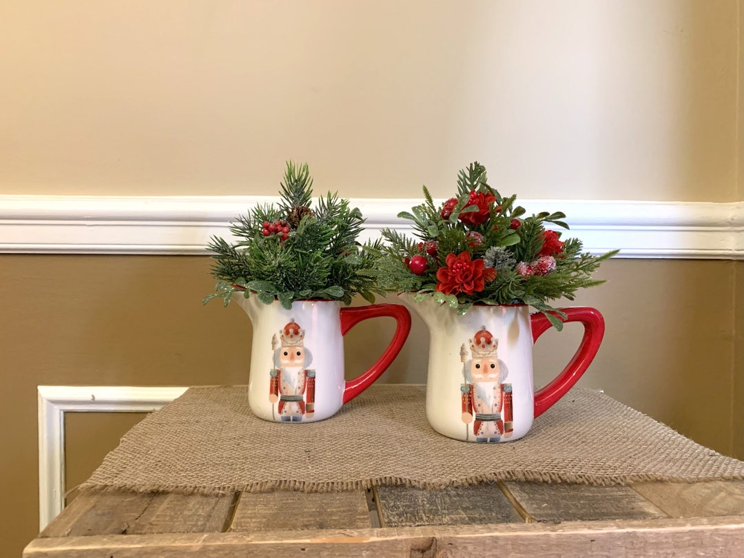 Nutcracker Creamer With Artificial Pine and Red Flowers Red Nutcracker