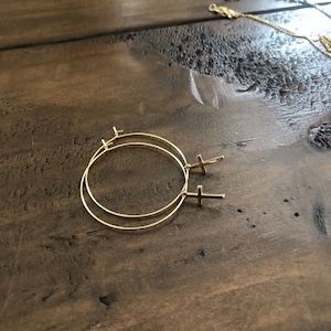dangle cross earrings. hoop earrings.