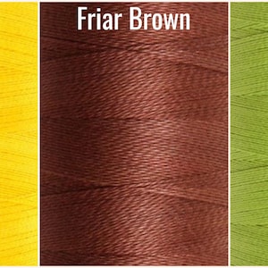 May include: Three spools of thread in different colors: yellow, brown, and green. The thread is wound tightly and has a smooth texture.