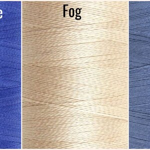 May include: Three spools of thread in different colors: Dazzling Blue, Fog, and Denim.