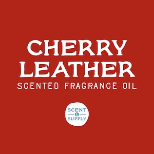 May include: A red background with white text that reads "CHERRY LEATHER SCENTED FRAGRANCE OIL". A white circle with a blue outline and the text "SCENT & SUPPLY" is in the bottom right corner.