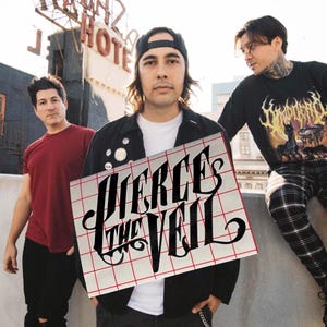 May include: A group of three people posing outdoors. One person holds a sign with the text "PIERCE THE VEIL" in a stylized font. The sign has a red grid pattern. The people are wearing casual clothing.