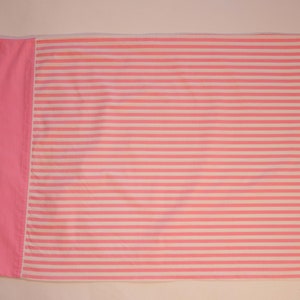 May include: Pink and white striped fabric with a solid pink border. The fabric is folded in half.