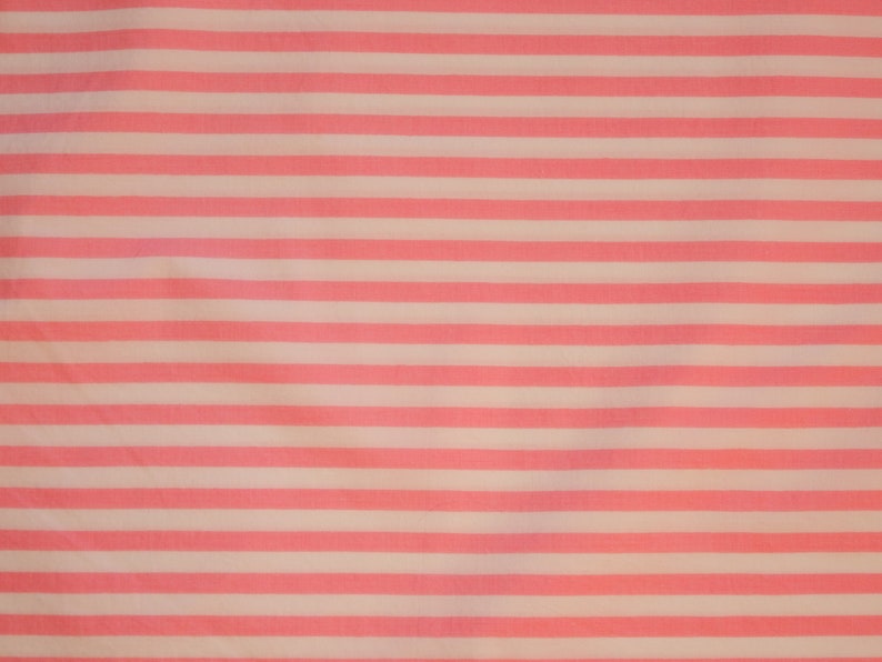 May include: Pink and white striped fabric with a subtle texture. The fabric is smooth and has a soft, delicate feel.