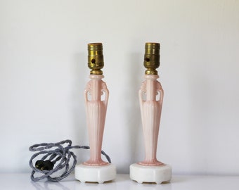 Pair of Aladdin alacite boudoir lamps with pink center column, white base and black and white twisted fabric cord