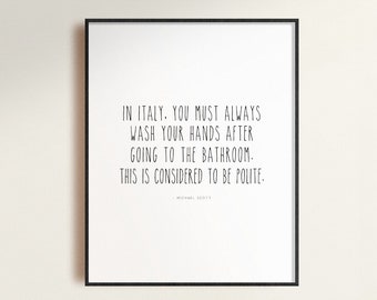 May include: A black and white framed print with the text "IN ITALY. YOU MUST ALWAYS WASH YOUR HANDS AFTER GOING TO THE BATHROOM. THIS IS CONSIDERED TO BE POLITE."