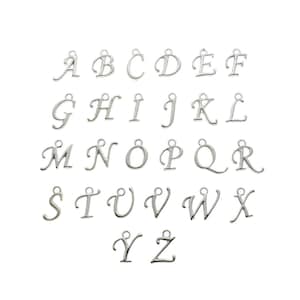 May include: A set of 26 silver metal alphabet letter charms. Each letter is in a cursive font style.