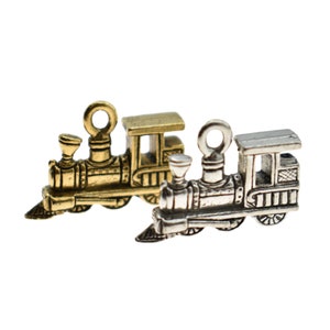 May include: Two miniature train engine charms, one gold and one silver, with detailed features like wheels, a smokestack, and a caboose.
