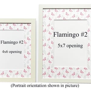 May include: Two white picture frames with a flamingo pattern border. The frames have openings for 4x6 and 5x7 inch photos. Text on the frames reads "Flamingo #2" and "Portrait orientation shown in picture".