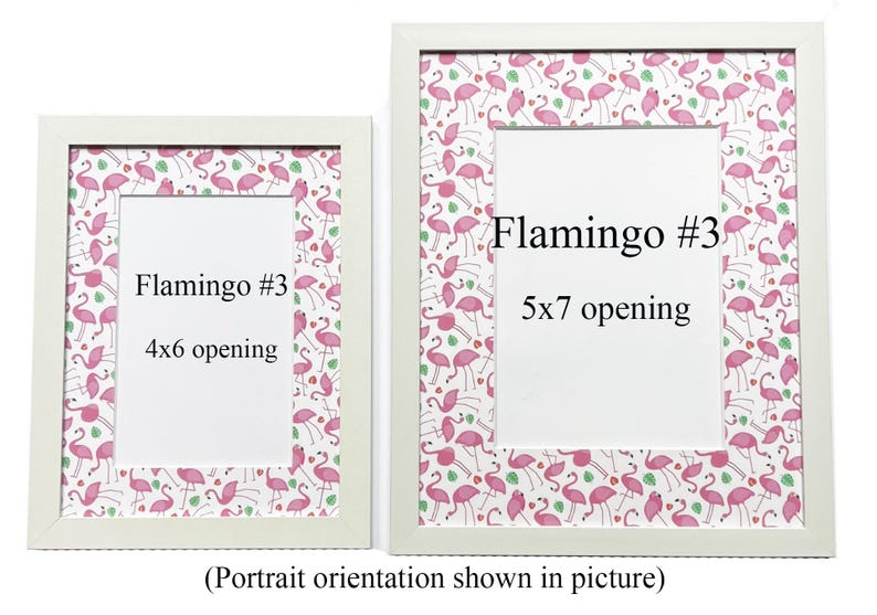 May include: Two white picture frames with flamingo-themed patterned borders. The frames have white matting and openings for 10x15 cm and 13x18 cm photos. Text on the frames reads "Flamingo #3" and indicates the opening sizes. The image is in portrait orientation.