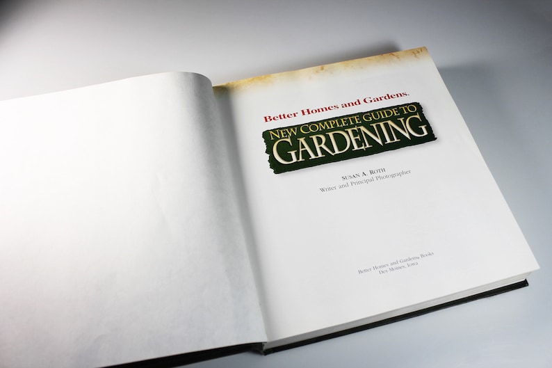 May include: A closed book titled "Better Homes and Gardens. New Complete Guide to Gardening" with a green and gold title on a white background.