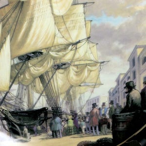 May include: Decorative plate featuring a detailed painting of a tall ship docked at a port. The ship has large white sails and is surrounded by people and buildings. The plate has a black border.