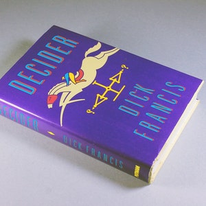 May include: A purple hardcover book titled "Decider" by Dick Francis. The cover features a colorful illustration of a person riding a white horse.
