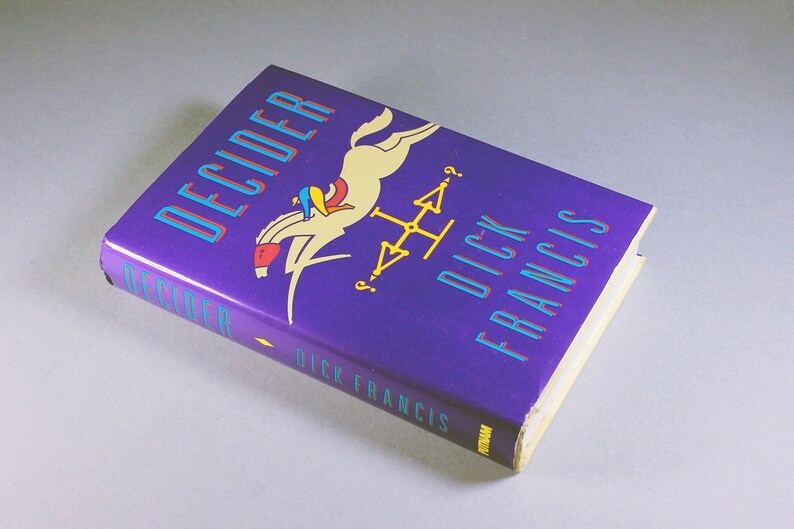May include: A purple hardcover book titled "Decider" by Dick Francis. The cover features a colorful illustration of a person riding a white horse.