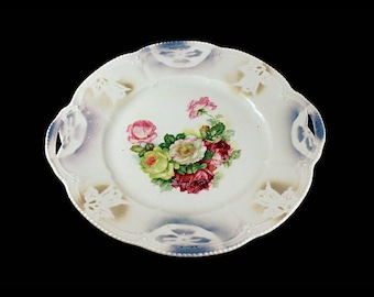 May include: A white porcelain serving plate with a floral design featuring pink, red, and yellow roses. The plate has two handles and a scalloped edge.