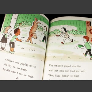 May include: A children's book illustration showing a group of children playing with a brown dog. The dog is doing a handstand. The children are smiling and laughing. The text on the page reads: "Children were playing there! Barkley was so happy he did some tricks for them."