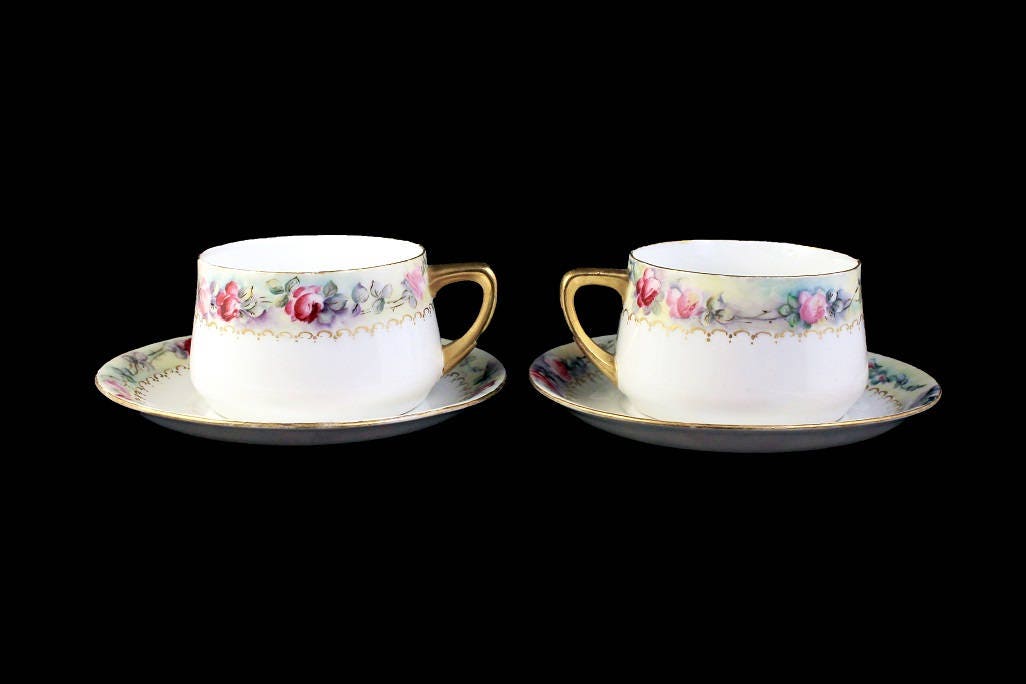 Weimer porcelain set of five cabinet demi cups and saucers.