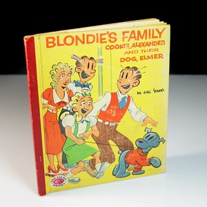 May include: A vintage book cover featuring a cartoon family, Blondie's Family, with the title "Blondie's Family, Cookie, Alexander and their Dog, Elmer" by Chic Young. The cover is yellow with red and blue accents.