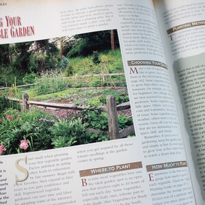 May include: A close-up of a page from a gardening book with a photo of a vegetable garden. The text on the page reads "Planning Your Vegetable Garden" and "Choosing Your Crops".