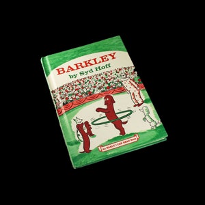 May include: A green book titled "Barkley by Syd Hoff" with a red dog jumping through a hoop. The book is part of the "As Easily I Can Read Book" series.