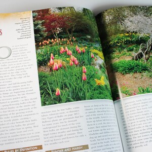 May include: A close-up of a book page with the title "About Bulbs" and a photo of a garden with pink and yellow tulips. The text discusses the importance of planting bulbs in the fall and how they provide a beautiful display of color in the spring.