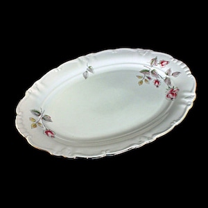 May include: White oval serving platter with a gold rim and a floral design featuring pink roses and green leaves.