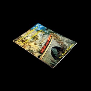 May include: A book cover with a red and yellow train traveling through a tunnel. The book title is "British and European Model Railways" by Paul Mallary.
