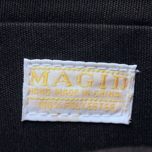 May include: White label with gold stitching and the text "MAGID HAND MADE IN CHINA 100% POLYESTER"