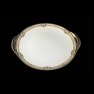 May include: A white oval serving platter with gold trim and a floral design. The platter has two handles.