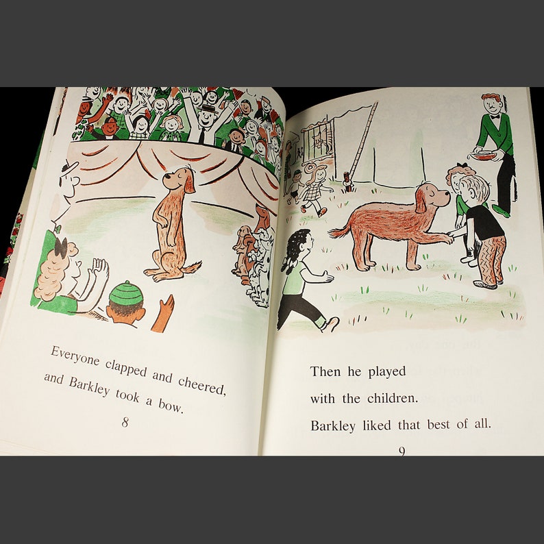 May include: A brown dog stands on its hind legs on a stage with a red and white striped tent. The dog is surrounded by a crowd of people clapping and cheering. The text "Everyone clapped and cheered, and Barkley took a bow." is printed below the image.