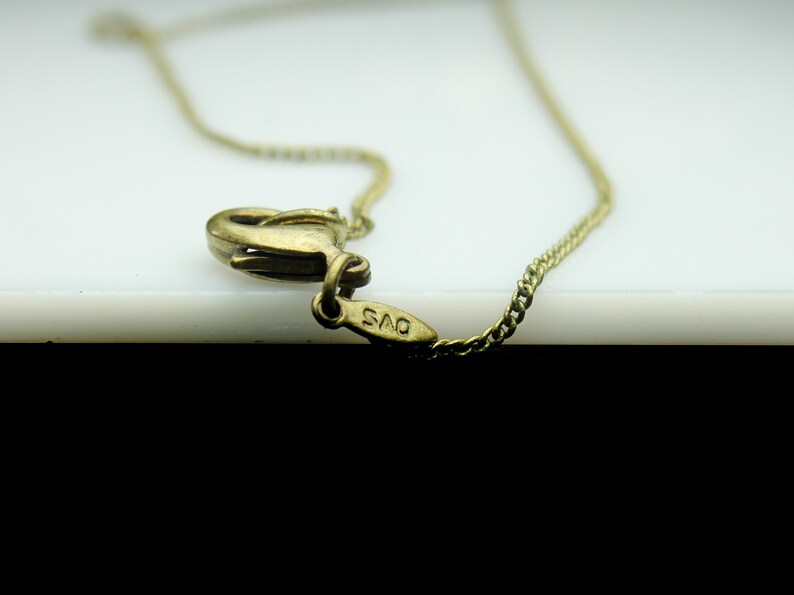May include: A gold chain necklace with a clasp that has the inscription "925" on it.