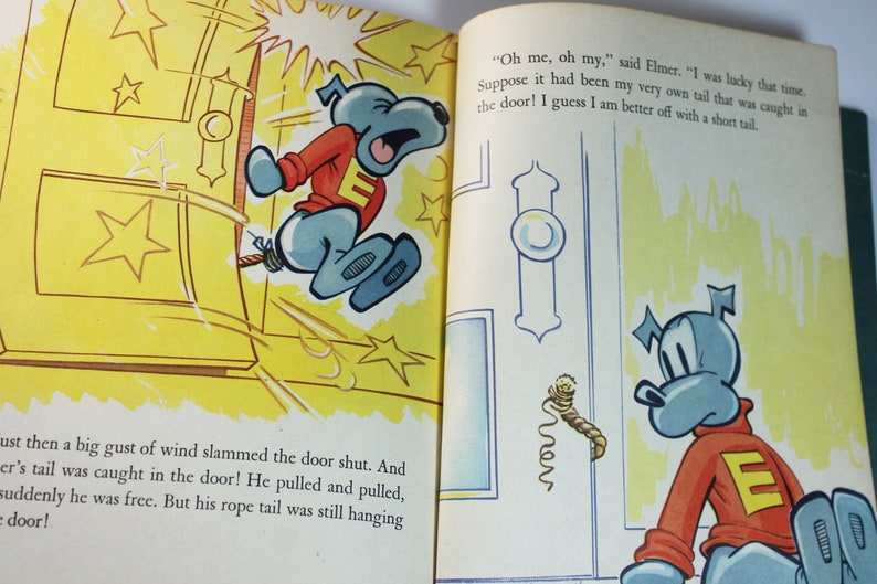 May include: A cartoon dog with a blue body and red shirt with a white letter E is stuck in a yellow door. The dog is pulling on a rope tail. The text in the image reads "Oh me, oh my, said Elmer. "I was lucky that time Suppose it had been my very own tail that was caught in the door! I guess I am better off with a short tail"