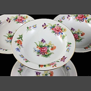May include: Set of four white porcelain soup bowls with a gold rim and a floral design featuring pink, red, yellow, and blue flowers.