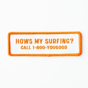 May include: Orange embroidered patch with a white background. The text reads "Hows My Surfing? Call 1-800-Yougood".