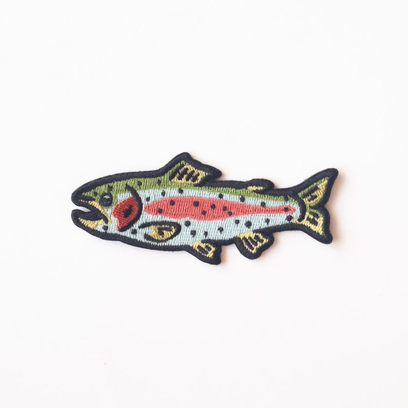 May include: An embroidered iron-on patch of a rainbow trout fish with green, red, and blue details. The fish is outlined in black.