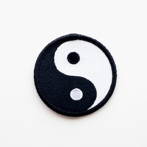 May include: A black and white yin yang symbol embroidered on a round patch.