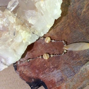 Honey jade pendant necklace with added beads on metal chain