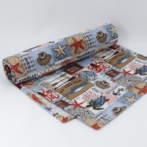 May include: A blue and white fabric with a nautical theme. The fabric features a variety of sea creatures, including starfish, seashells, and an octopus. The fabric also has the words "Ocean", "Seashells", "Beach House", and "By the Sea" printed on it.