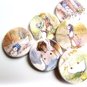 May include: Set of six round wooden buttons featuring illustrations from the children's book "The Tale of Peter Rabbit". The buttons depict various characters from the story, including Peter Rabbit, Jemima Puddle-Duck, and Mr. McGregor.