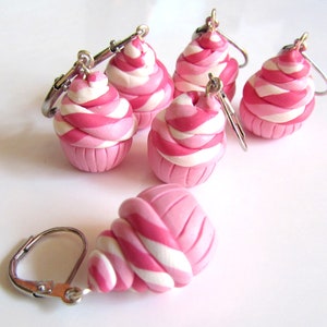 May include: Five pink and white swirl cupcake charm earrings with silver hooks.