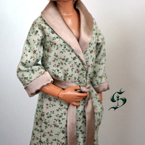 May include: A green and brown floral print robe with a satin collar and sash. The robe has long sleeves and a tie waist.