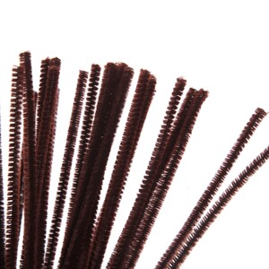 Puede incluir: Primer plano de un grupo de limpiapipas marrones. Estos materiales de manualidades, difusos y texturizados, est&aacute;n dispuestos sobre un fondo blanco. Estos tallos flexibles, con alambre en el centro, se utilizan a menudo en proyectos art&iacute;sticos.