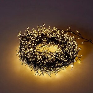 May include: A string of warm white fairy lights with a copper wire, coiled into a circle. The lights are small and have a warm glow.