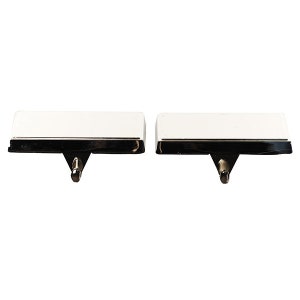 May include: Two white ceramic stocking holders with a chrome trim and a hook on the bottom.