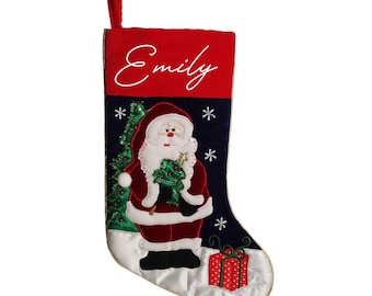 May include: A red and blue Christmas stocking with a Santa Claus design. The stocking has a white satin cuff and the name "Emily" embroidered on the red cuff.
