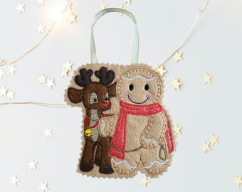May include: A felt Christmas ornament featuring a gingerbread man and a reindeer. The gingerbread man is wearing a red scarf and the reindeer has a bell around its neck.