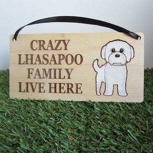 May include: Wooden sign with the text "Crazy Lhasapoo Family Live Here" and a white cartoon dog illustration.